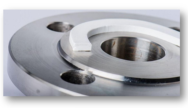 금속 프렌지 배관 연결 부위에 흰색 테이프형 씰을 부착하여 밀봉하는 실제 사용 예시